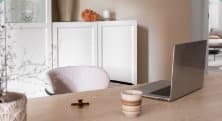 A bright home office with a laptop on a wooden desk